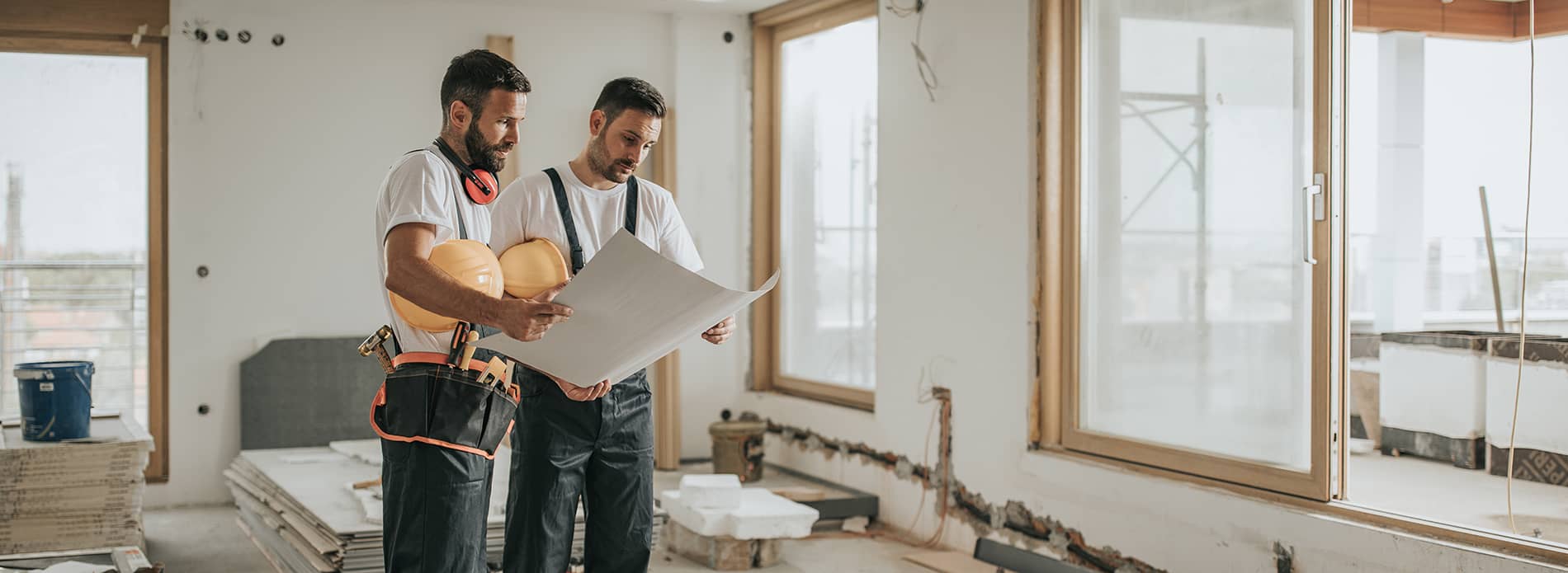 2 men looking at plans on a building site