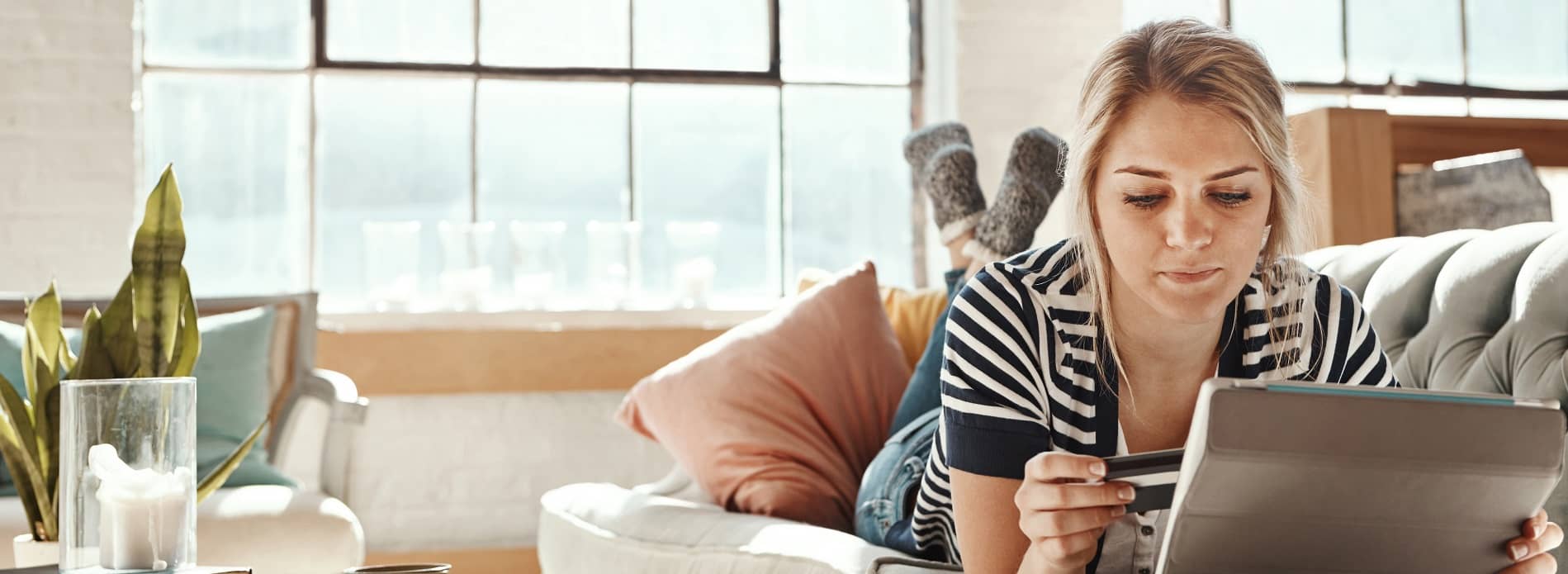 woman laying on her front looking at computer
