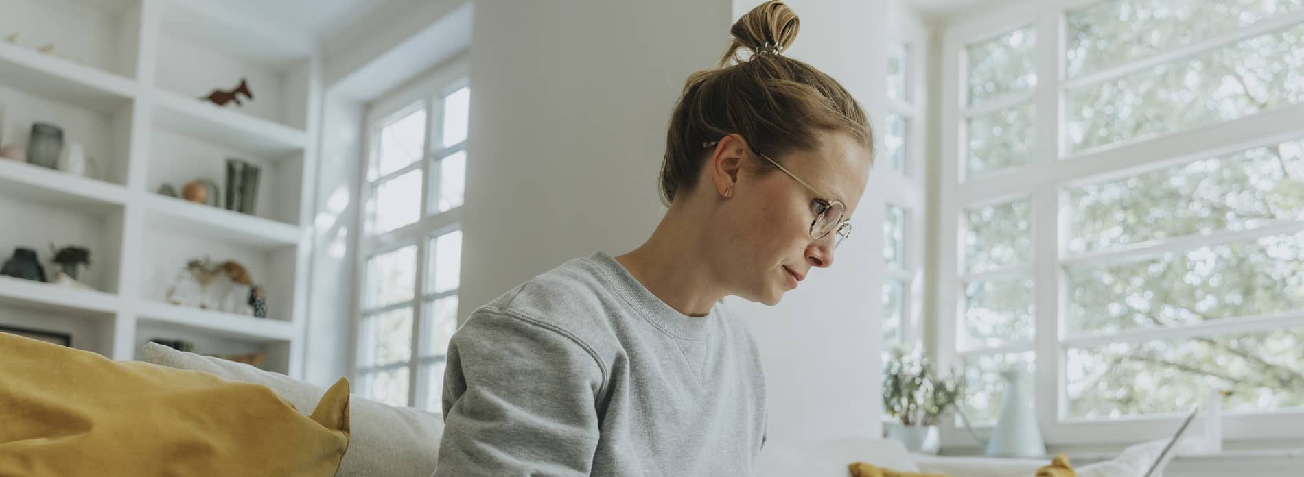 Woman at home on sofa